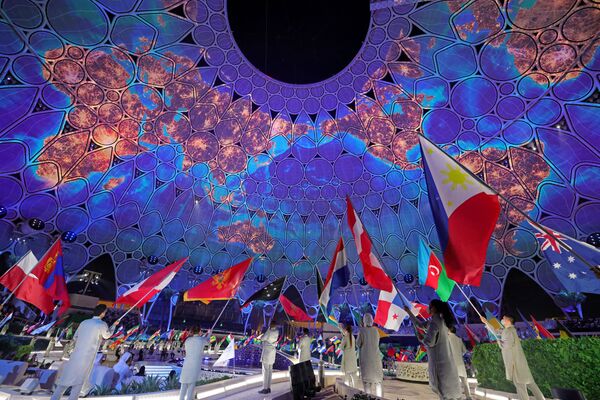 Flag-bearers of the participating nations enter during the opening ceremony of the Dubai Expo 2020. - Sputnik International