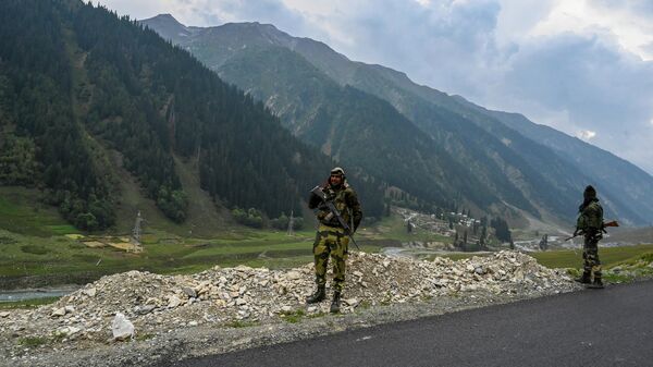 Paramilitary soldiers stand guard near the under-construction Zojila tunnel, which will connect Srinagar to the union territory of Ladakh, in Baltal on September 28, 2021 - Sputnik International