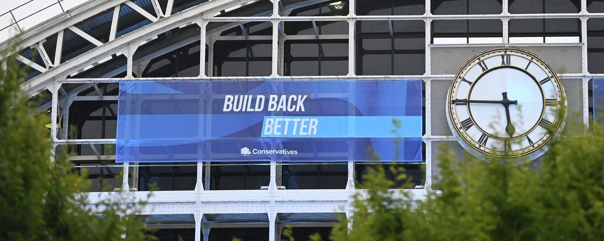 A political banner hangs on the outside of the Manchester Central Convention Complex at the annual Conservative party conference in Manchester - Sputnik International, 1920, 02.10.2021