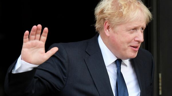 Britain's Prime Minister Boris Johnson gestures as he walks out of his hotel during the annual Conservative Party conference, in Manchester, Britain, October 3, 2021 - Sputnik International