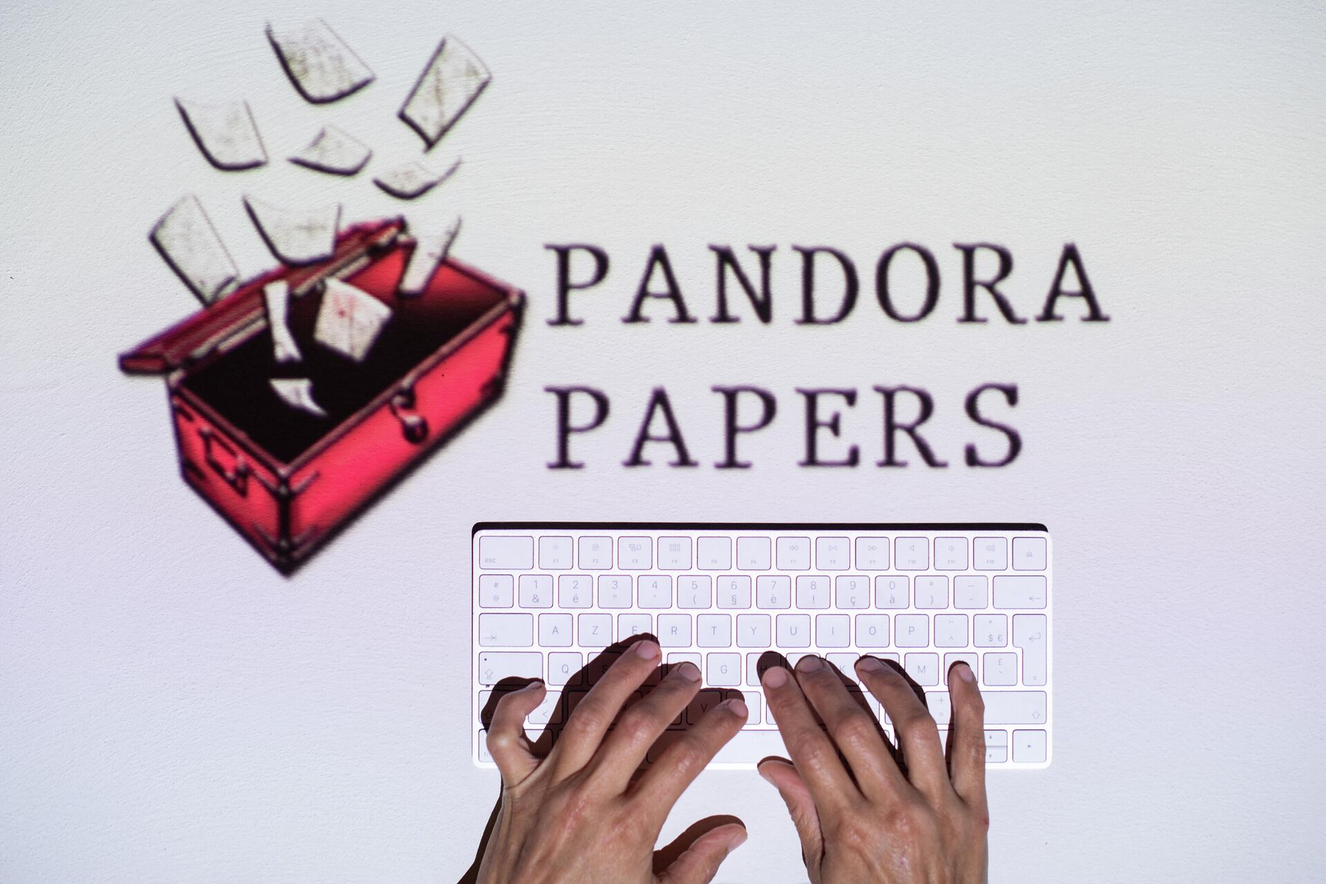 This photograph illustration shows hands typing on a keyboard in front of the logo of Pandora Papers, in Lavau-sur-Loire, western France, on October 4, 2021 - Sputnik International, 1920, 11.10.2021
