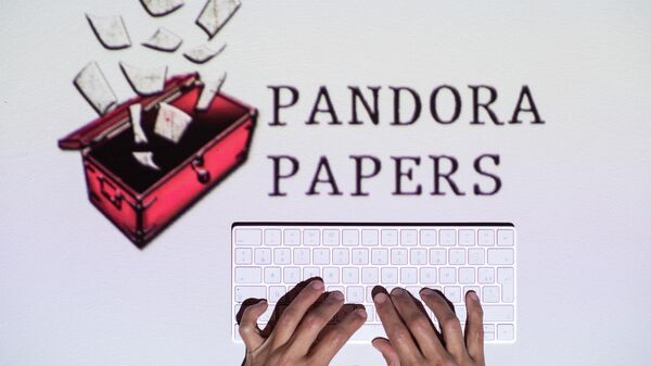 This photograph illustration shows hands typing on a keyboard in front of the logo of Pandora Papers, in Lavau-sur-Loire, western France, on October 4, 2021 - Sputnik International