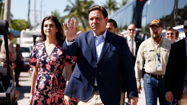 Florida Gov. Ron DeSantis and his wife, Casey, arrive to visit a memorial to those missing outside the 12-story Champlain Towers South condo building that partially collapsed on July 03, 2021, in Surfside, Florida.  - Sputnik International