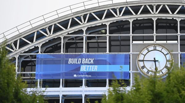 A political banner hangs on the outside of the Manchester Central Convention Complex at the annual Conservative party conference in Manchester, Britain - Sputnik International