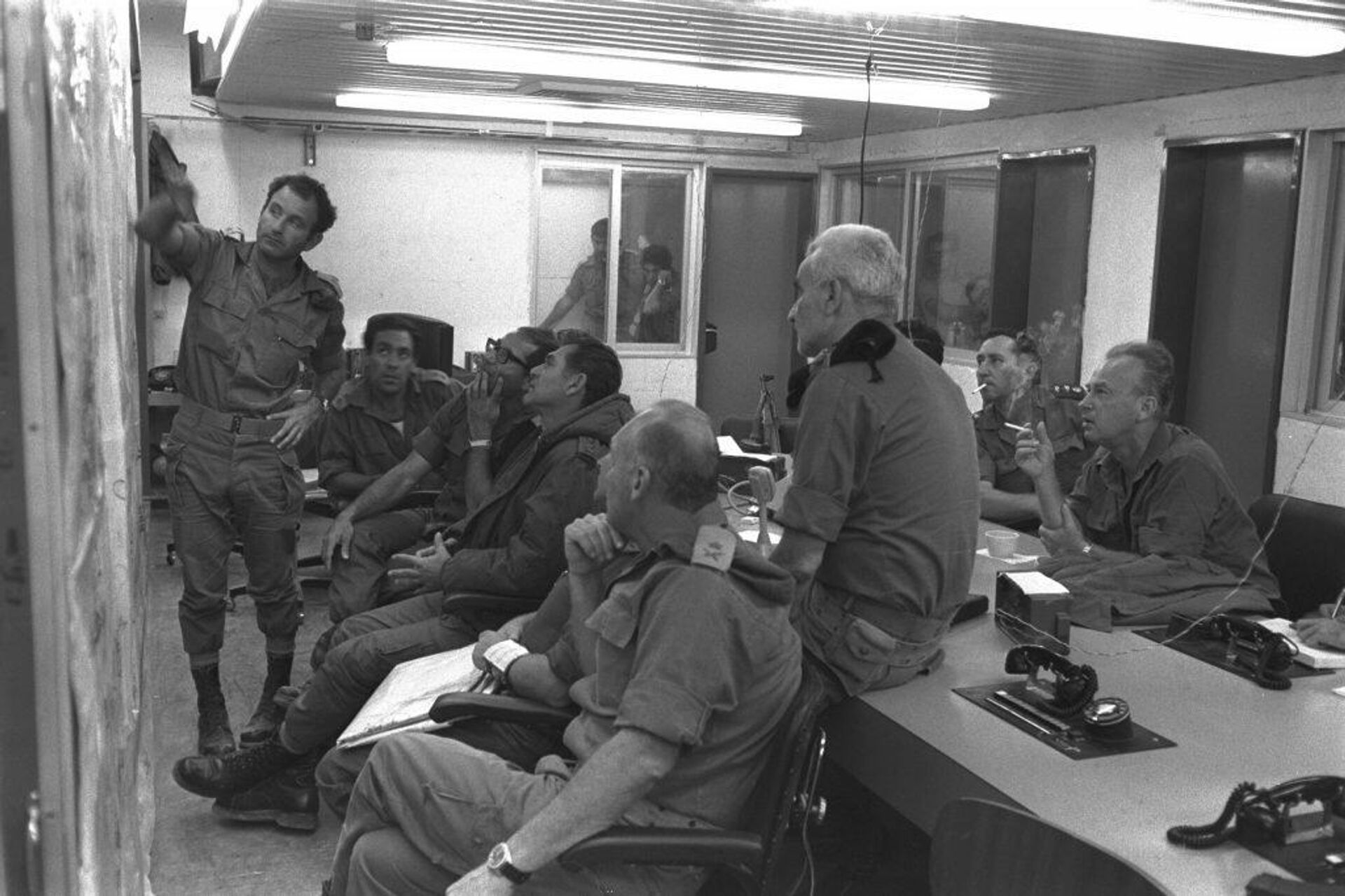 A consultation in the War Room of Southern Command, with Chief of Staff Elazar (third from the right), on his left OC Southern Command Gonen (Gorodish). Behind them: the ex-Chief of Staff Yitzhak Rabin, 8 October 1973. Photograph: Shlomo A - Sputnik International, 1920, 06.10.2021