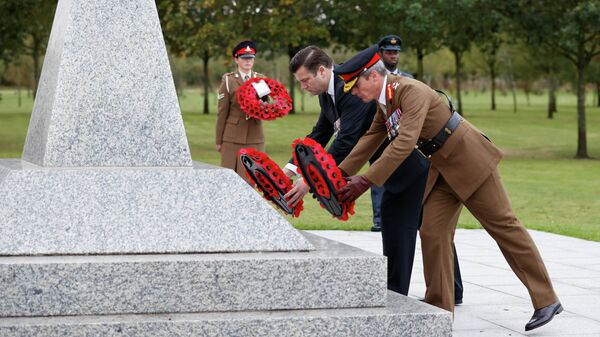 Minister of the Armed Forces James Heappey and Major General Gerald Stricklands lay wreaths during a memorial service at the Camp Bastion Memorial at the National Memorial Arboretum in Staffordshire, Britain, October 7, 2021. REUTERS/Phil Noble - Sputnik International