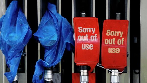 FILE - In this Sept. 30, 2021, file photo, fuel pumps are marked out of use at a petrol station in London. Britain is experiencing empty gas pumps, worker shortages and gaps on store shelves - Sputnik International