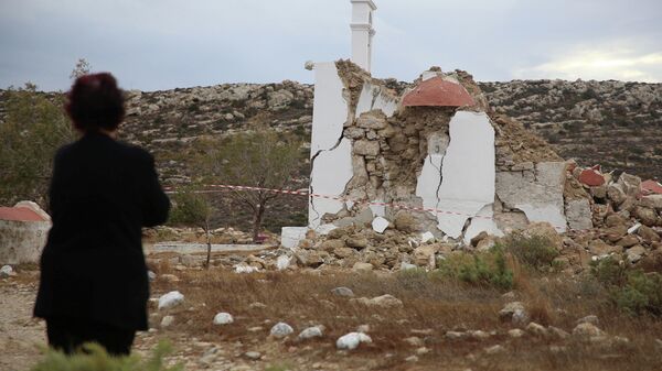 A local looks at a destroyed chapel following an earthquake in the village of Xerokampos on the island of Crete, Greece - Sputnik International