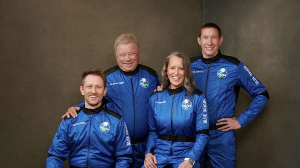 This handout photo released by Blue Origin Media shows the four member Blue Origin crew (from R) Glen de Vries, Audrey Powers, Canadian actor William Shatner and Chris Boshuizen posing at an undisclosed location on October 10, 2021. - Blue Origin announced on October 10 that it was delaying its flight set to carry actor William Shatner to space due to anticipated winds. - Sputnik International