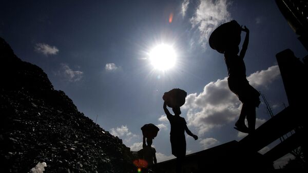 FILE- In this Oct. 20, 2010 file photo, Indian laborers carry coal to load on a truck in Gauhati, India - Sputnik International