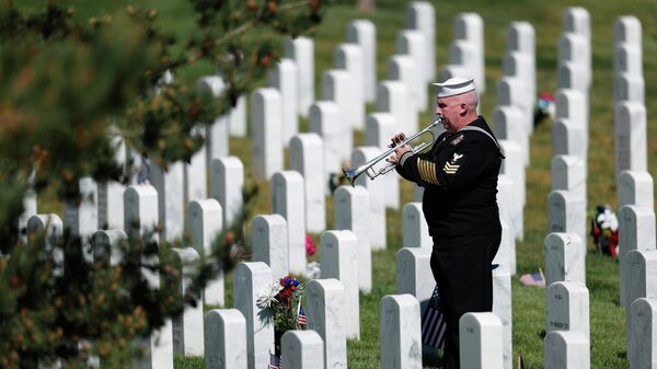 Retired U.S. Navy Yeoman First Class Mark Stallins plays Taps for Memorial Day at a gravesite in Fort Logan National Cemetery Monday, May 25, 2020, in Sheridan, Colo. - Sputnik International