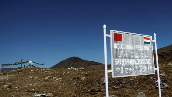 FILE PHOTO: A signboard is seen from the Indian side of the Indo-China border at Bumla, in the northeastern Indian state of Arunachal Pradesh, November 11, 2009. Picture taken November 11, 2009 - Sputnik International