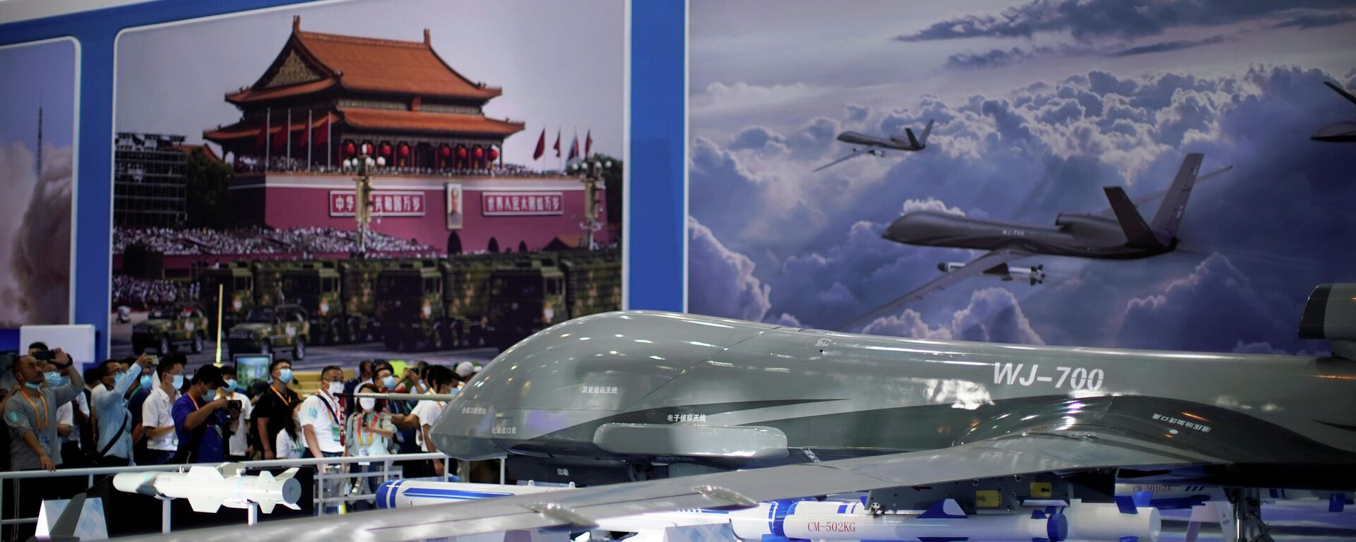 Visitors stand near a model of WJ-700 armed reconnaissance drone displayed at the China International Aviation and Aerospace Exhibition, or Airshow China, in Zhuhai, Guangdong province, China September 28, 2021 - Sputnik International, 1920, 14.10.2021