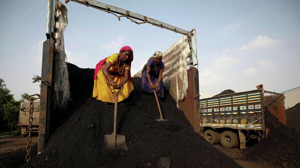 Workers unload coal from a supply truck at a yard on the outskirts of Ahmedabad, India October 12, 2021 - Sputnik International