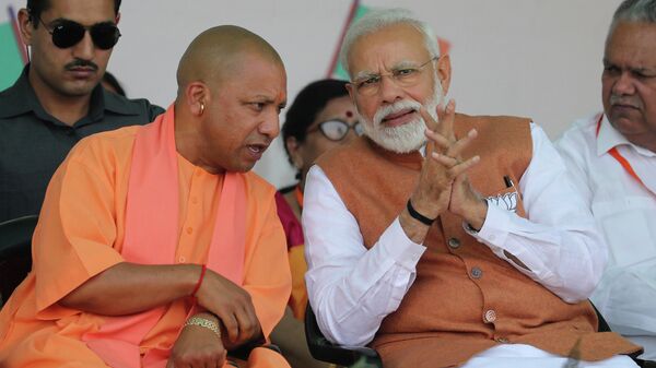 FILE- In this March 28, 2019, file photo, Indian Prime Minister Narendra Modi, right, speaks with Chief Minister of Uttar Pradesh state Yogi Adityanath during an election campaign rally in Meerut, India - Sputnik International