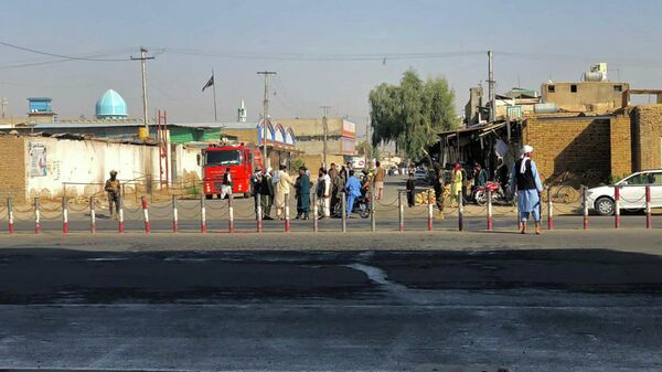 Members of Taliban stand guard near a Shiite mosque in Kandahar province on October 15, 2021, after at least 16 people were killed and 32 wounded when explosions hit a Shiite mosque - Sputnik International