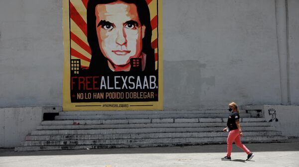 A woman walks by a mural in support of the liberation of businessman Alex Saab, who was detained in Cape Verde on charges of laundering money for the government of Venezuelan President Nicolas Maduro, in Caracas - Sputnik International