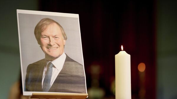 A candle and a portrait of British MP David Amess are seen at the church of St Michael's and all Angels, in Leigh-on-Sea - Sputnik International