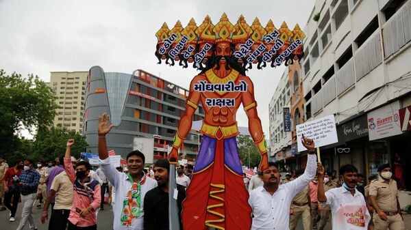 India's opposition Congress party supporters carry a cut-out of demon king Ravana symbolising inflation during a protest against hike in fuel prices in Ahmedabad, India, Tuesday, July 20, 2021 - Sputnik International