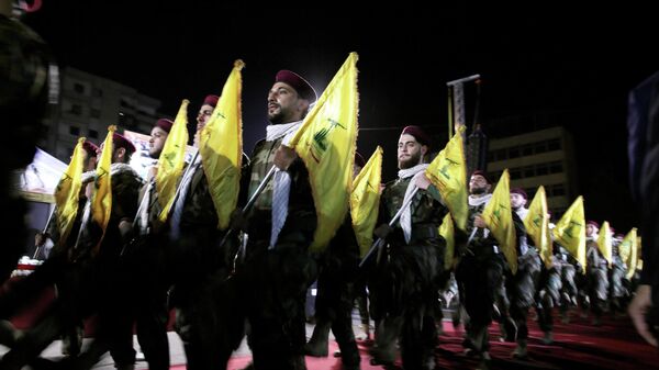  In this May 31, 2019 file photo, Hezbollah fighters march at a rally to mark Jerusalem day or Al-Quds day, in the southern Beirut suburb of Dahiyeh, Lebanon. On Monday, Oct. 18, 2021, Hezbollah leader Sheik Hassan Nasrallah revealed that his militant group has 100,000 trained fighters. - Sputnik International