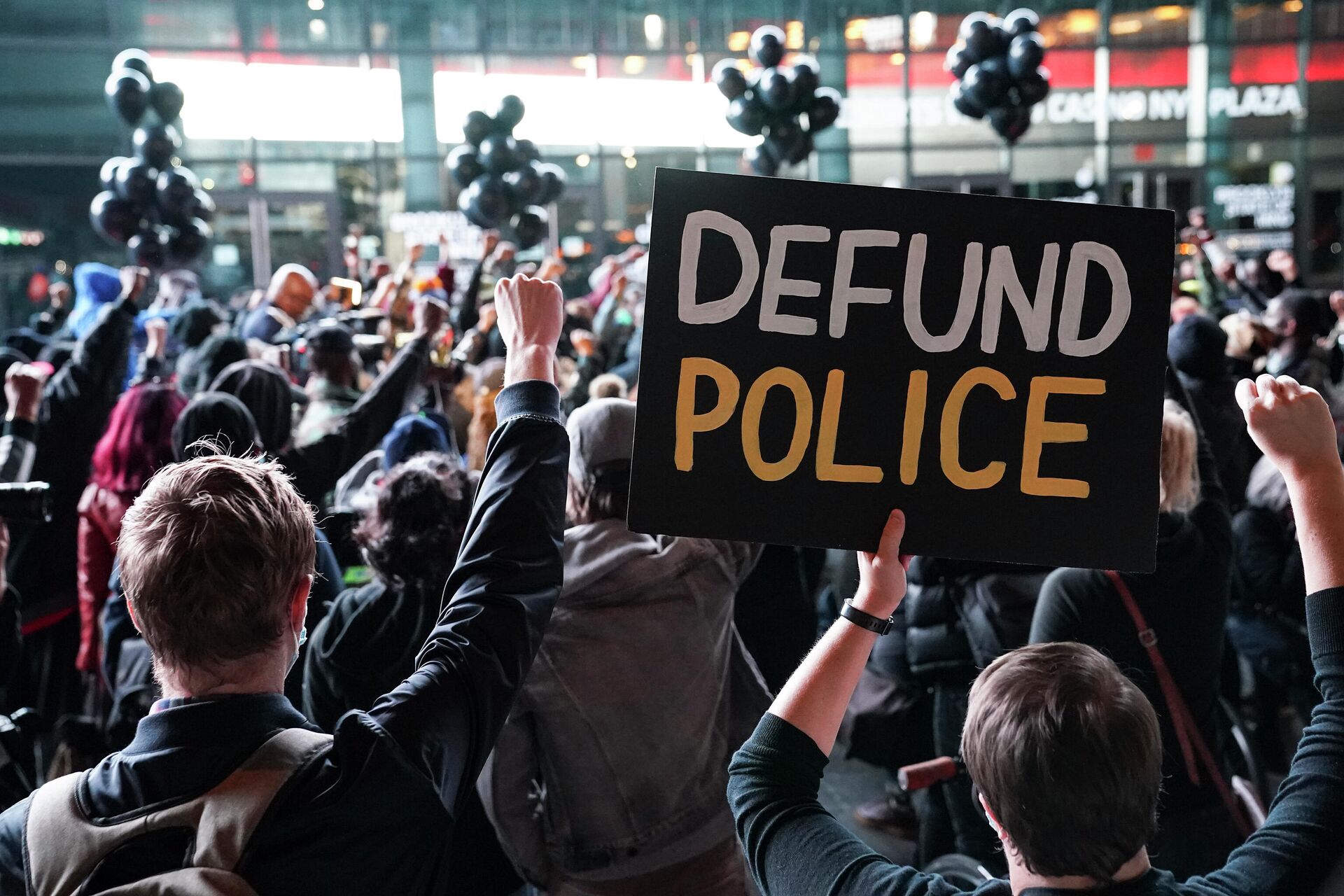 In this Oct. 14, 2020, file photo a protester holds a sign that reads Defund Police during a rally for the late George Floyd outside Barclays Center in New York. - Sputnik International, 1920, 20.10.2021