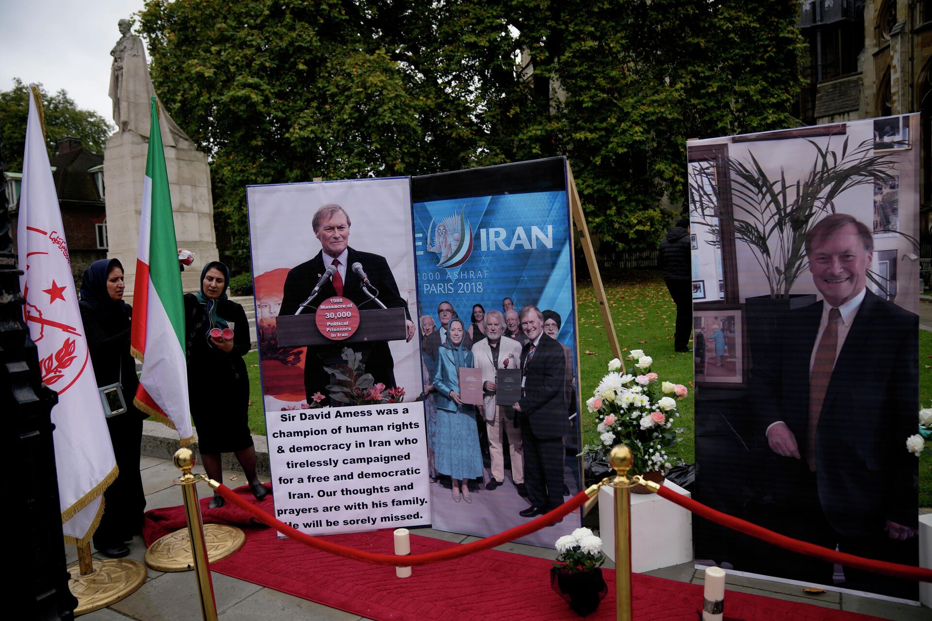 Images of British Member of Parliament David Amess are displayed opposite the Houses of Parliament in London, placed there as a memorial by supporters of the National Council of Resistance of Iran (NCRI), Monday, Oct. 18, 2021 - Sputnik International, 1920, 22.11.2021