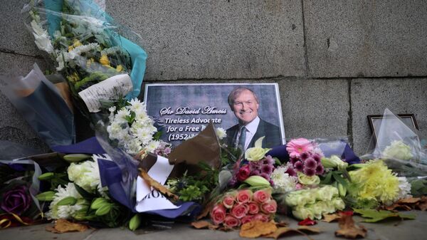 Floral tributes to British MP David Amess, who was stabbed to death during a meeting with constituents, lay outside the Houses of Parliament, in London, Britain, October 19, 2021 - Sputnik International