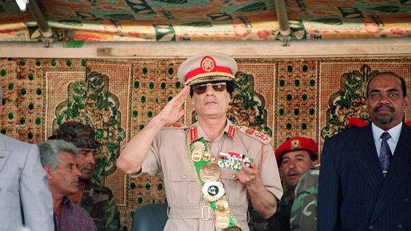 Libyan leader colonel Muammar Gaddafi (C), salutes troops during a military parade on 1 September 1994 in Tripoli for the celebration of the 25th anniversary of his arrival in power.  - Sputnik International