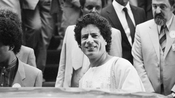 Libyan leader Muammar Gaddafi smiles to photographers as he leaves the African Hall during the second day of a pre-Summit Committee meeting at the 19th Summit of the Organization of African Unity in Addis Ababa, 7 June 1983.  - Sputnik International