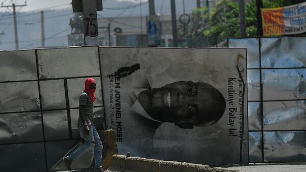 A billboard of slain Haitian President Jovenel Moise is used to block a road during an anti-government protest in Port-au-Prince, Haiti, Thursday, Oct. 21, 2021. - Sputnik International
