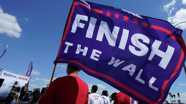 A participant holds a Finish The Wall flag at a March to the Border Rally, Saturday, Sept. 25, 2021, in McAllen, Texas. - Sputnik International