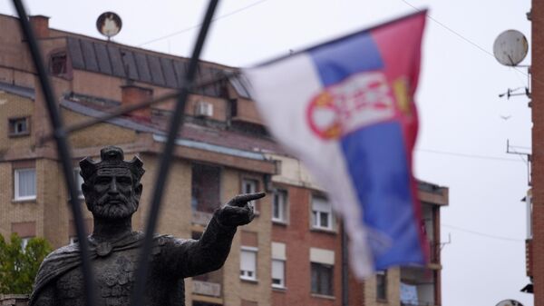A Serbian flag waves in front of the statue of Serbian Duke Lazar who was killed at the Battle of Kosovo in June 1389, in northern, Serb-dominated part of ethnically divided town of Mitrovica, Kosovo, Friday, Oct. 15, 2021.  - Sputnik International