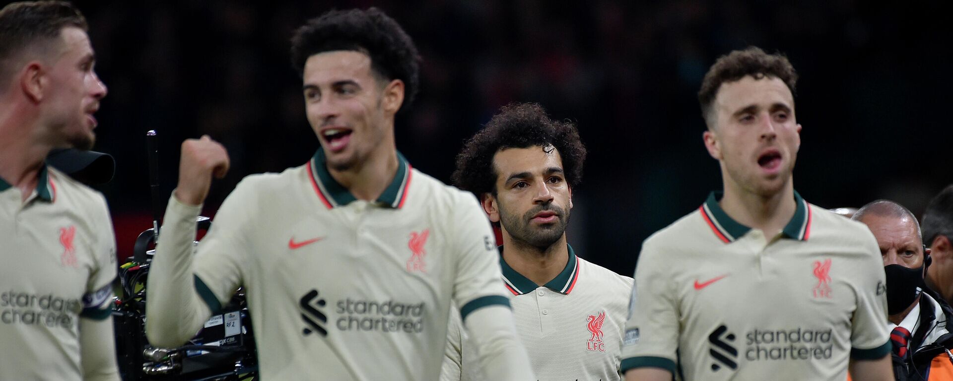 Liverpool's Mohamed Salah, background center, leaves the field with the match ball at the end of the English Premier League soccer match between Manchester United and Liverpool at Old Trafford in Manchester, England, Sunday, Oct. 24, 2021. - Sputnik International, 1920, 24.10.2021