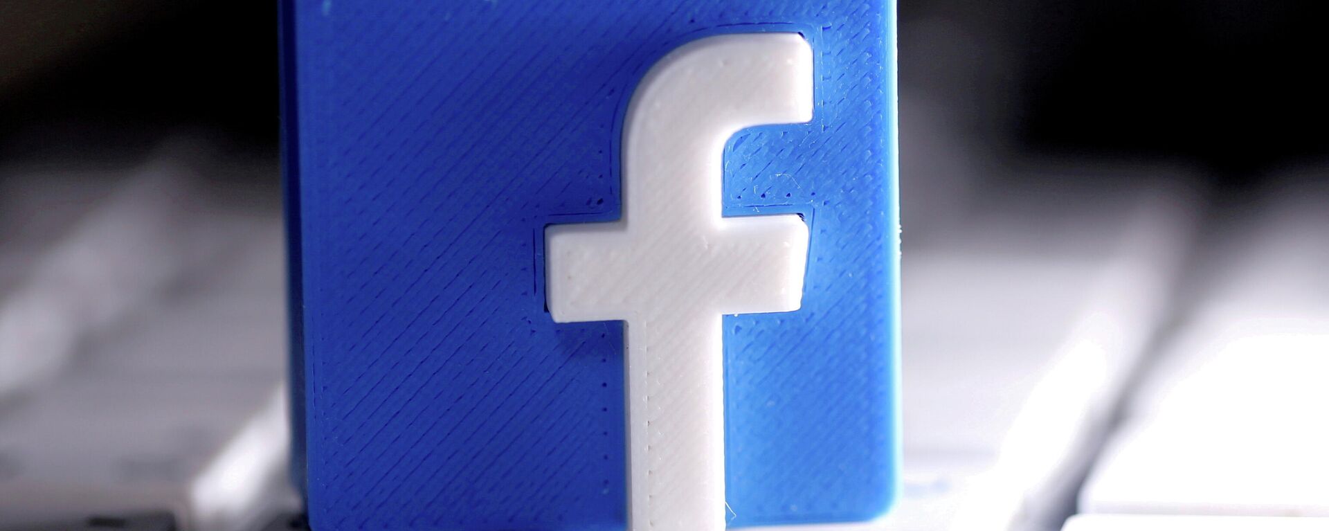 A 3D-printed Facebook logo is seen placed on a keyboard in this illustration taken March 25, 2020.  - Sputnik International, 1920, 09.11.2021