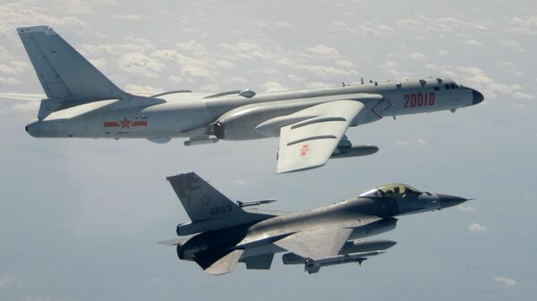 In this Feb. 10, 2020, file photo and released by the Republic of China (ROC) Ministry of National Defense, a Taiwanese Air Force F-16 in foreground flies on the flank of a Chinese People's Liberation Army Air Force (PLAAF) H-6 bomber as it passes near Taiwan - Sputnik International