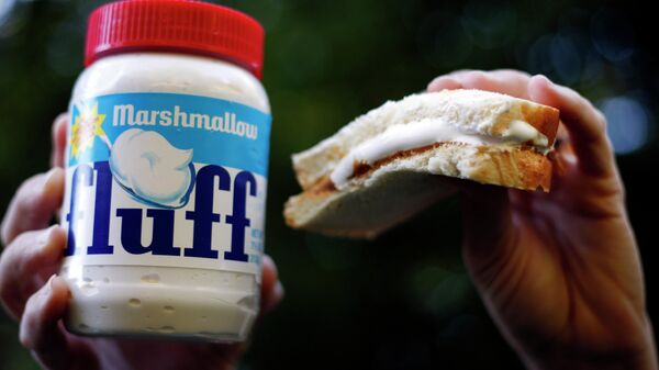 In this Sept. 27 2013 photo, a jar of Marshmallow Fluff and a Fluffernutter sandwich are held up for a photo in North Andover, Mass. - Sputnik International