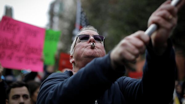 A demonstrator uses a whistle during a protest by New York City Fire Department (FDNY) union members, municipal workers and others, against the city's COVID-19 vaccine mandates on Manhattan's Upper East Side, in New York City, New York, U.S., October 28, 2021 - Sputnik International
