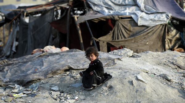 An internally displaced girl poses for photograph outside her temporary home in the city of Kabul, Afghanistan, Monday, Jan. 18, 2021. - Sputnik International