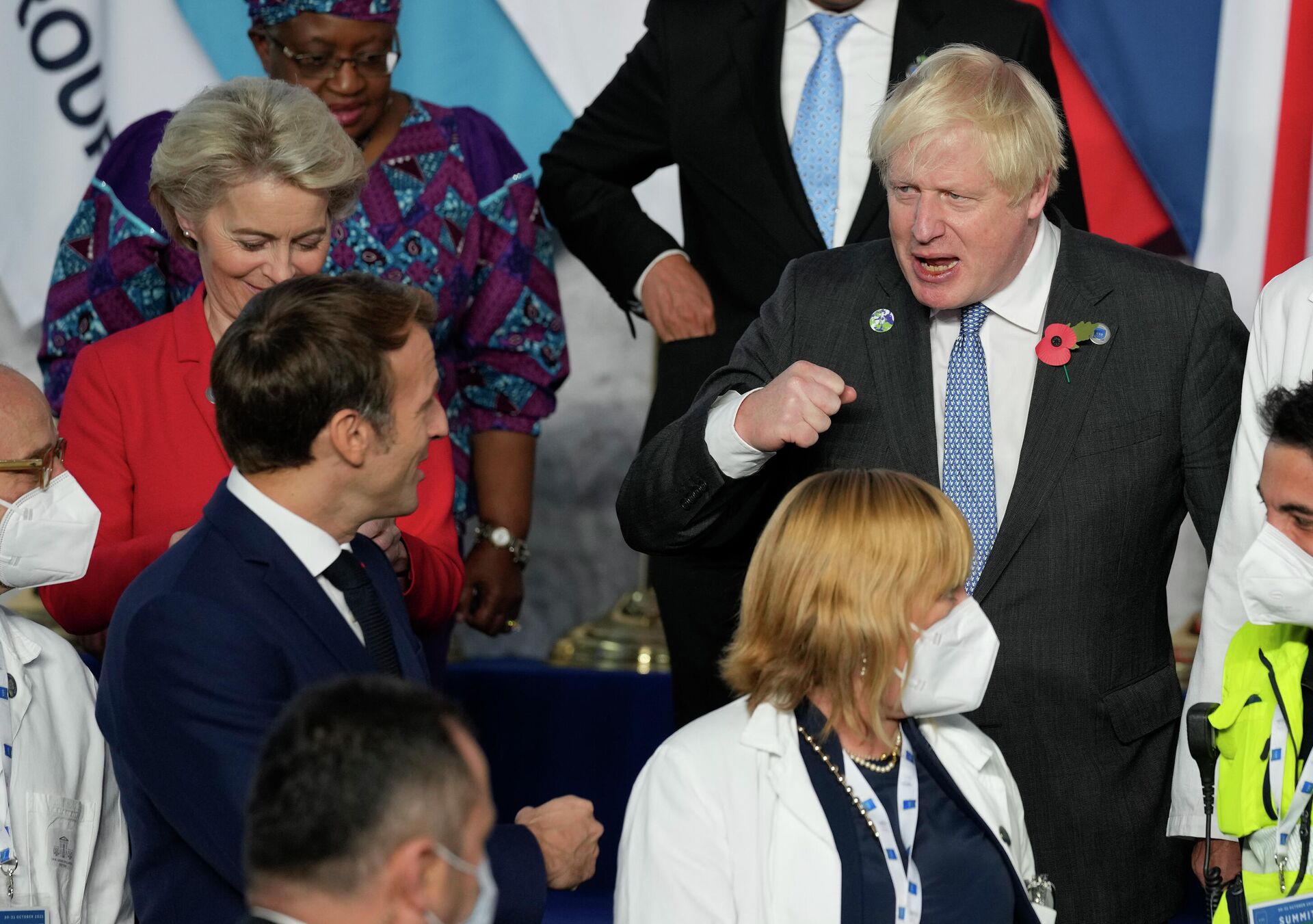 British Prime Minister Boris Johnson, center, pumps fists with French President Emmanuel Macron, left, during a group photo with medical personnel at the La Nuvola conference center for the G20 summit in Rome, Saturday, Oct. 30, 2021. - Sputnik International, 1920, 30.10.2021