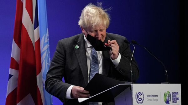 British Prime Minister Boris Johnson takes off his mask as he prepares to speak at the COP26 U.N. Climate Summit, in Glasgow, Scotland, Tuesday, Nov. 2, 2021 - Sputnik International