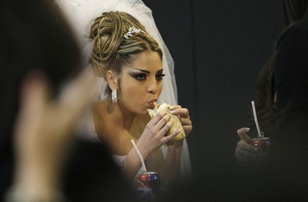 A model in a wedding gown eats a sandwich during her break at the &#x27;Wedding Folies&#x27; fair in the Lebanese capital of Beirut on 4 February 2010. - Sputnik International