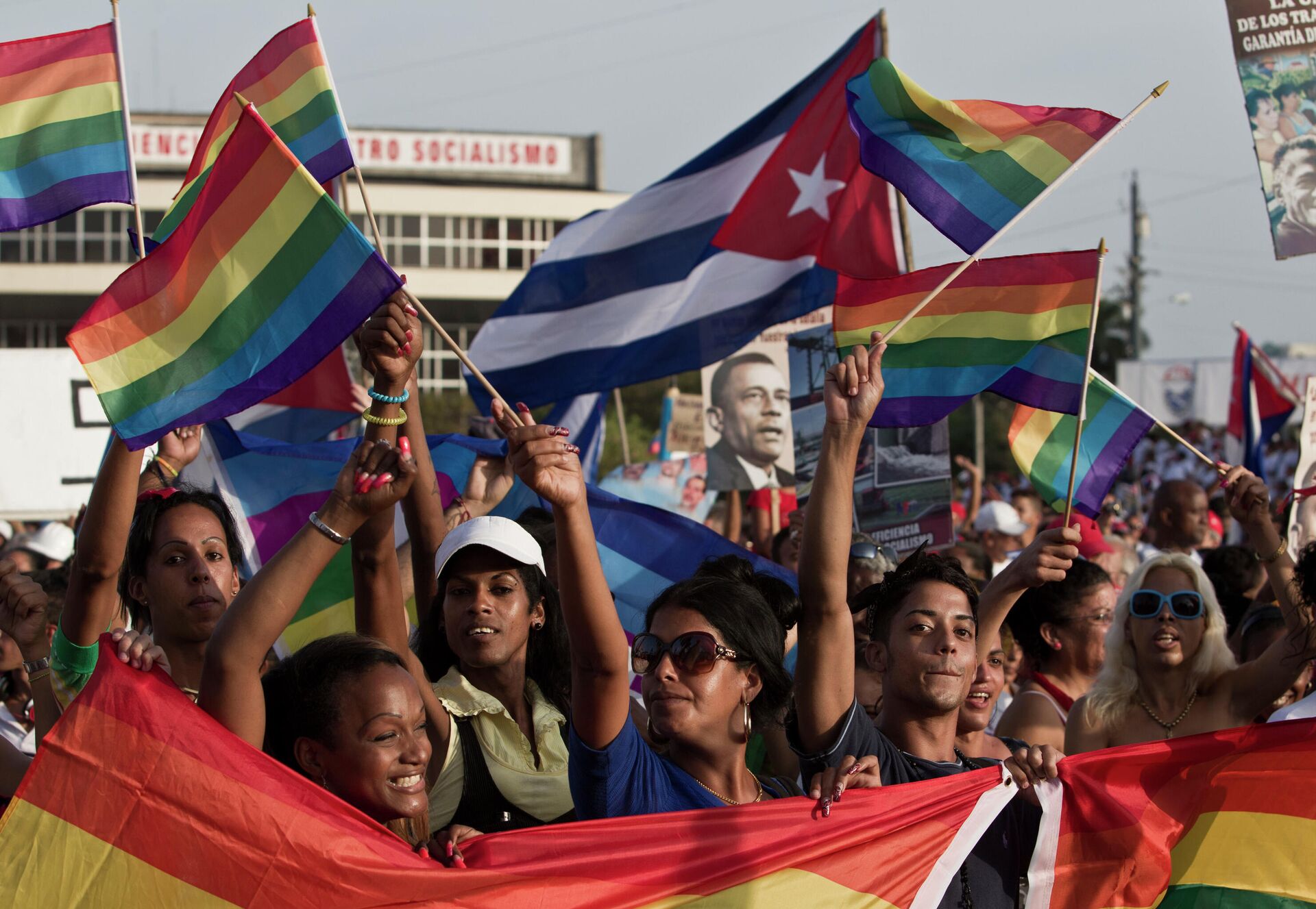LGBT community members march waving representations of Cuba's national flag and rainbow flags during May Day march in Havana, Cuba, Thursday, May 1, 2014. Cuba marks each May Day not with protests but with massive marches organized by workplaces, schools and government. Thousands of islanders filed through Havana's Revolution Plaza on Thursday to a soundtrack of congas, drums and cries of Long live the revolution!  - Sputnik International, 1920, 05.11.2021