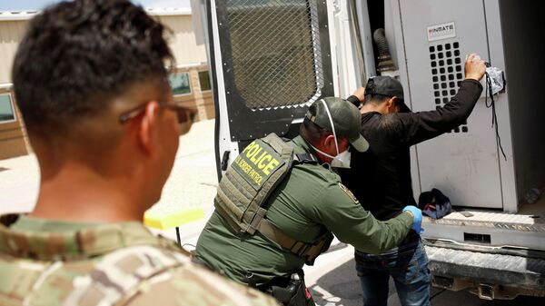 A member of the Border Patrol's Search, Trauma, and Rescue Unit (BORSTAR) observes a migrant from Central America who was detained by U.S. Customs and Border Protection (CBP) agents after crossing into the United States from Mexico, in Dona Ana County, New Mexico, U.S., July 15, 2021. - Sputnik International