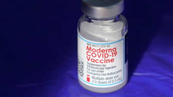 In this March 4, 2021 file photo, a vial of the Moderna COVID-19 vaccine rests on a table at a drive-up mass vaccination site in Puyallup, Wash., south of Seattle. - Sputnik International