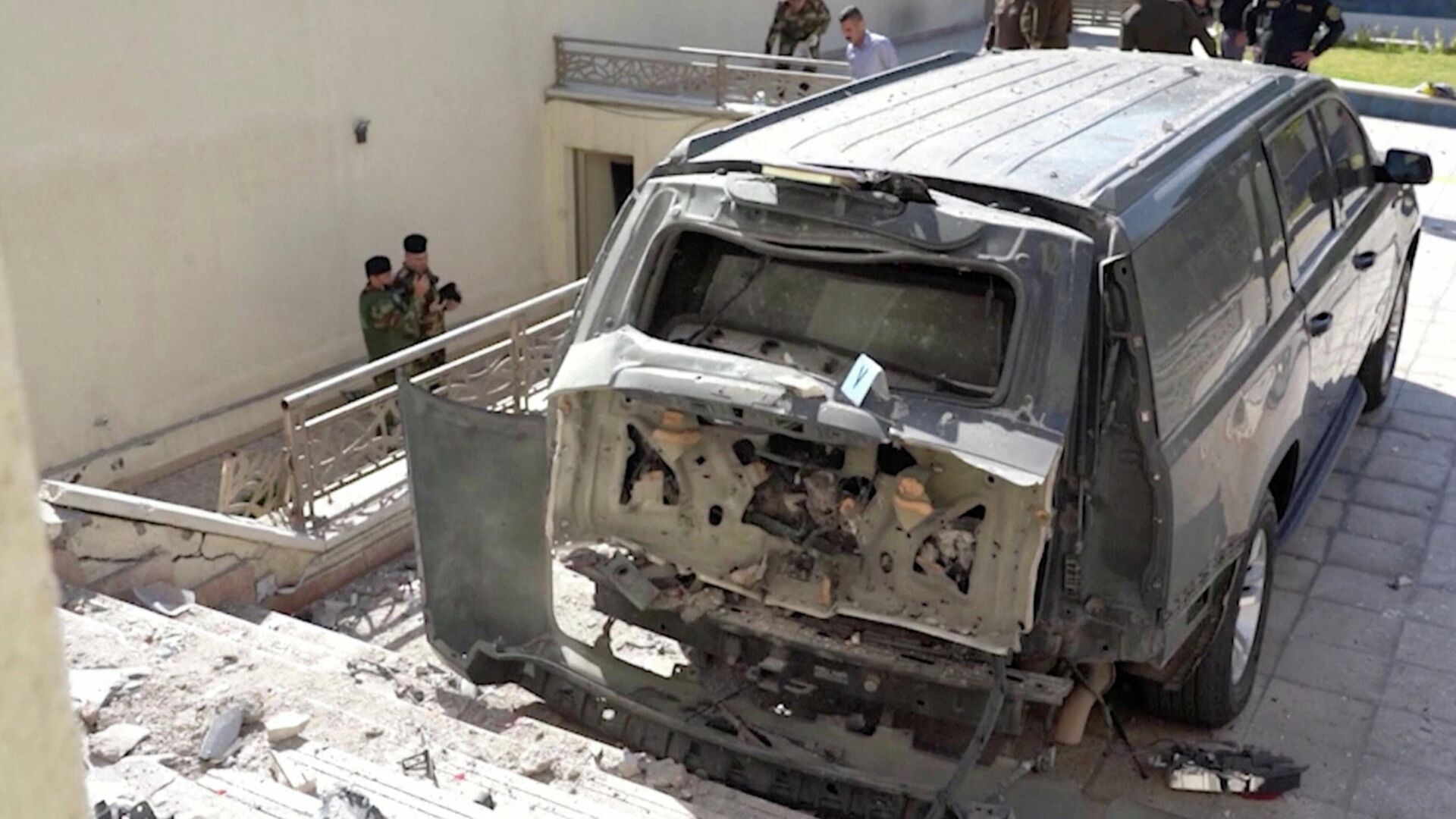 A destroyed vehicle is parked in front of Iraqi Prime Minister Mustafa al-Kadhimi's residence following an assassination attempt by an armed drone in Baghdad, Iraq in this screen grab taken from a handout video obtained by Reuters on November 7, 2021 - Sputnik International, 1920, 13.11.2021
