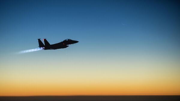 A U.S. Air Force F-15E Strike Eagle flies over northern Iraq early in the morning of Sept. 23, 2014, after conducting airstrikes in Syria. This F-15 was a part of a large coalition strike package that was the first to strike ISIL targets in Syria - Sputnik International