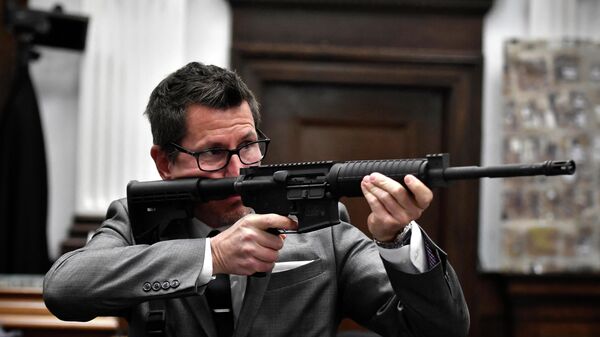 Assistant District Attorney Thomas Binger holds Kyle Rittenhouse's gun as he gives the state's closing argument in Kyle Rittenhouse's trial at the Kenosha County Courthouse on November 15, 2021 in Kenosha, Wisconsin.  - Sputnik International