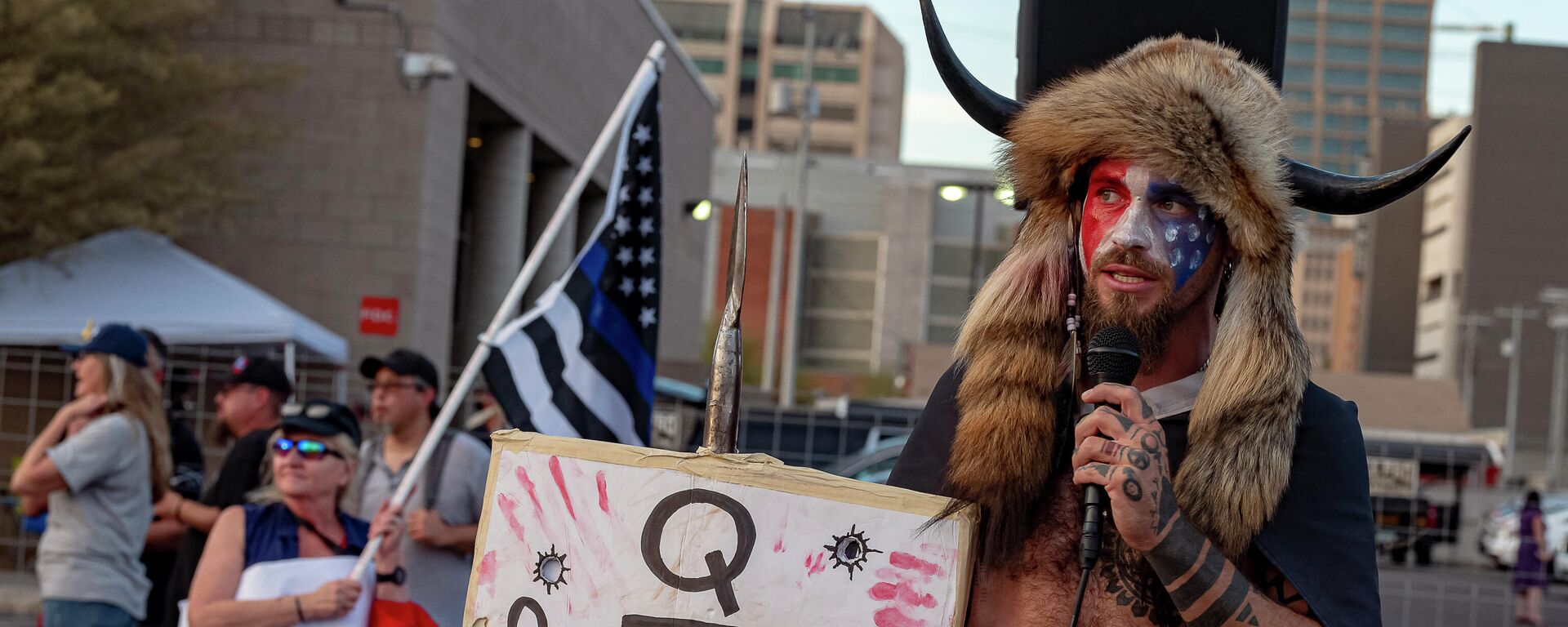 Jacob Chansley, known as the QAnon Shaman,  holds a sign reading Q Sent Me as supporters of US President Donald Trump gather to protest outside the Maricopa County Election Department as counting continues after the US presidential election in Phoenix, Arizona, on November 5, 2020. - Sputnik International, 1920, 07.03.2023