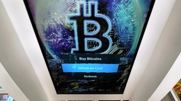 In this Feb. 9, 2021, file photo, the Bitcoin logo appears on the display screen of a cryptocurrency ATM in Salem, N.H. - Sputnik International