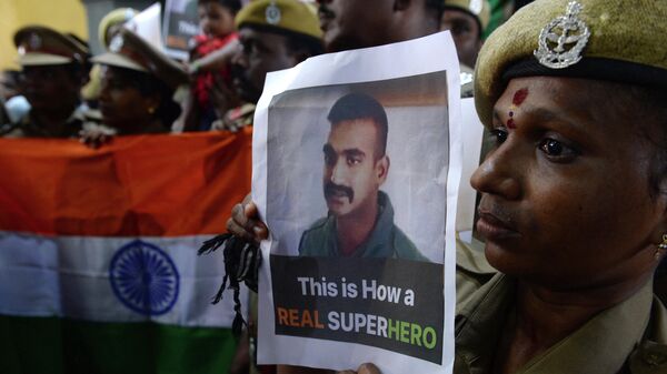 Indian security forces pose with the national flag and pictures of Indian Air Force pilot Abhinandan Varthaman during an event to pray for his return, at Kalikambal temple in Chennai on March 1, 2019.  - Sputnik International